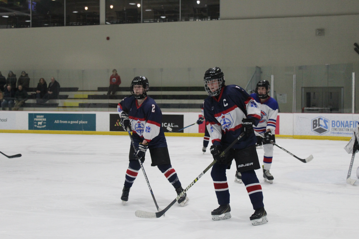 three female hockey players on an ice rink