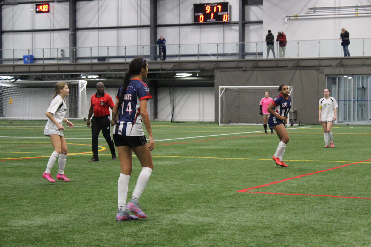 a group of women playing indoor soccer