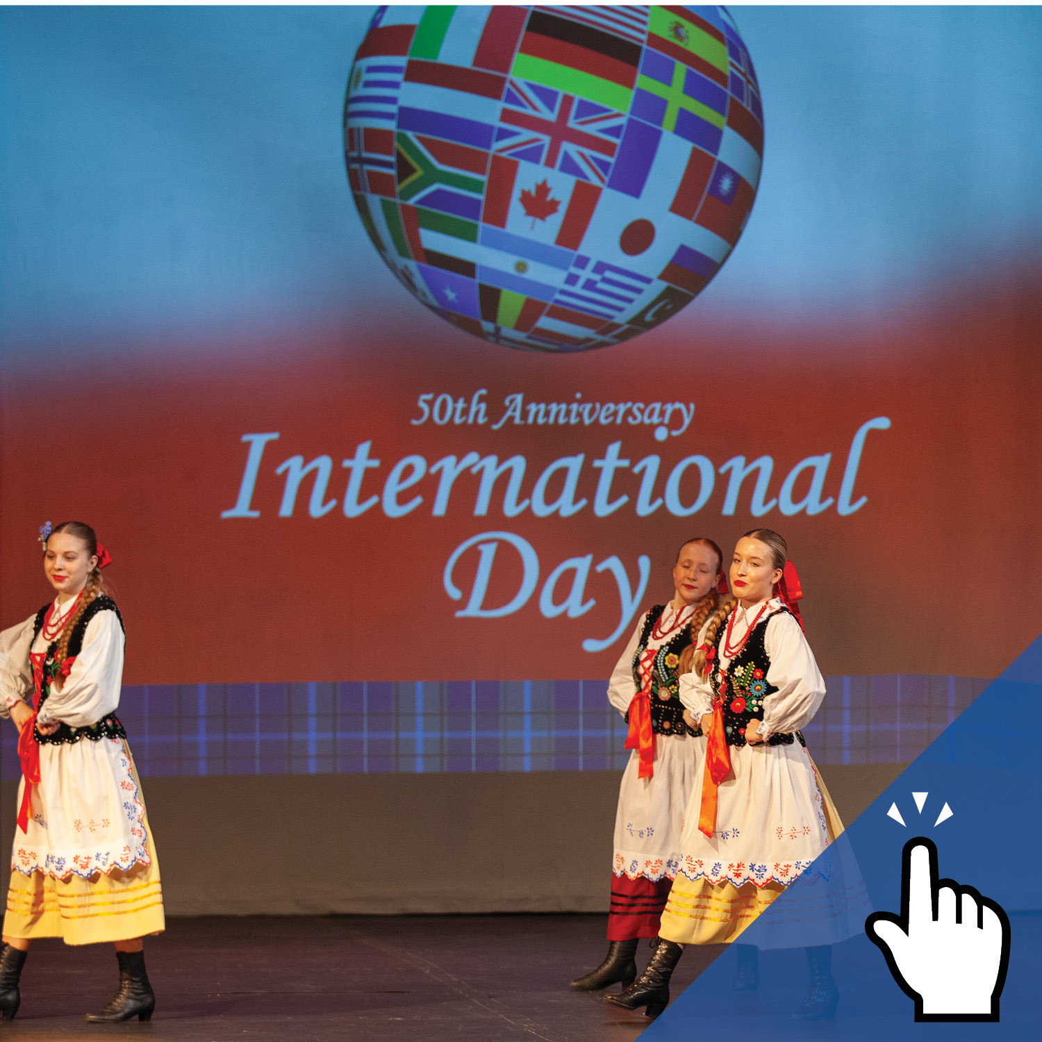 three female students performing a dance on stage