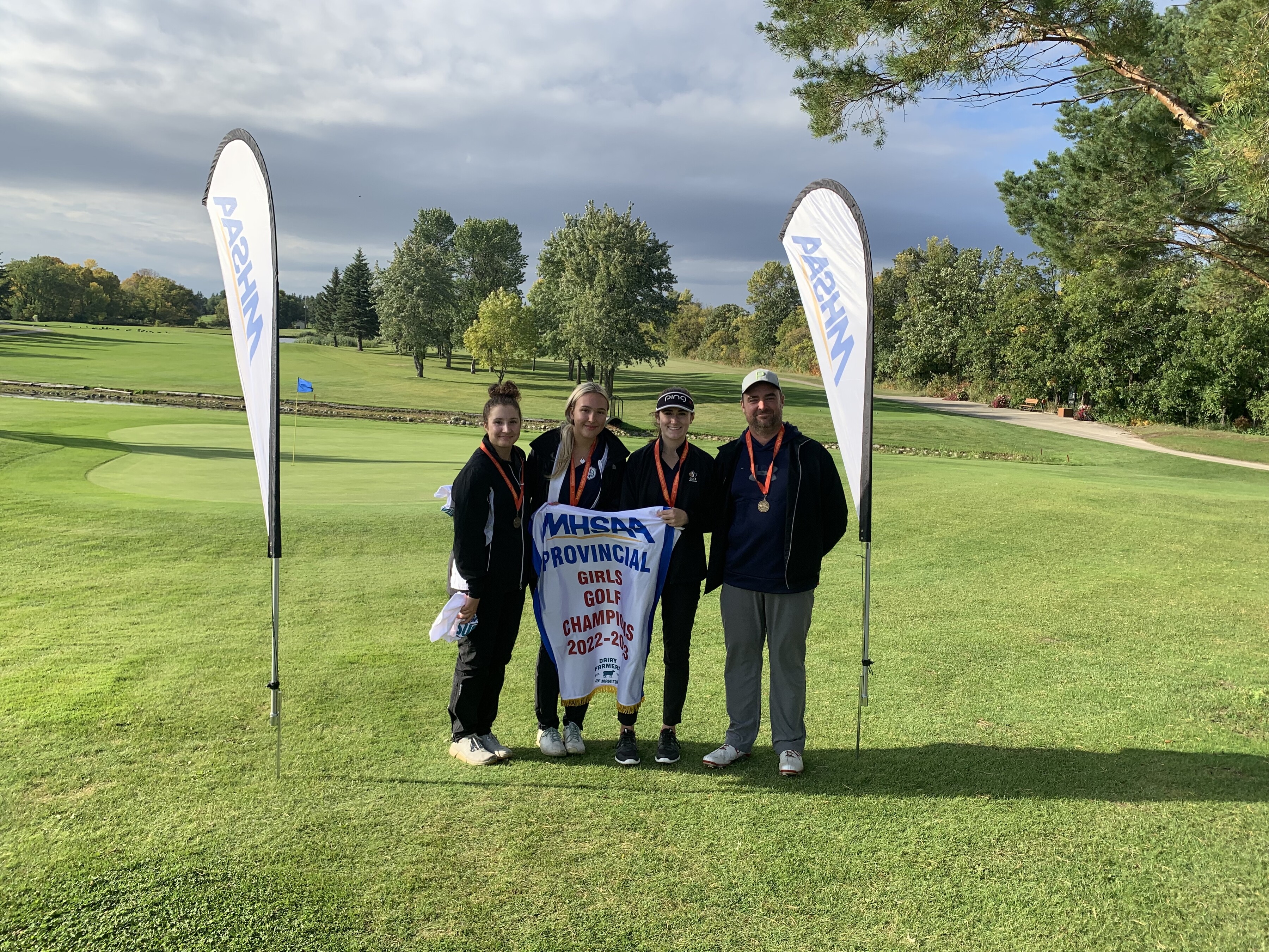 three SMA golf players and a male teacher