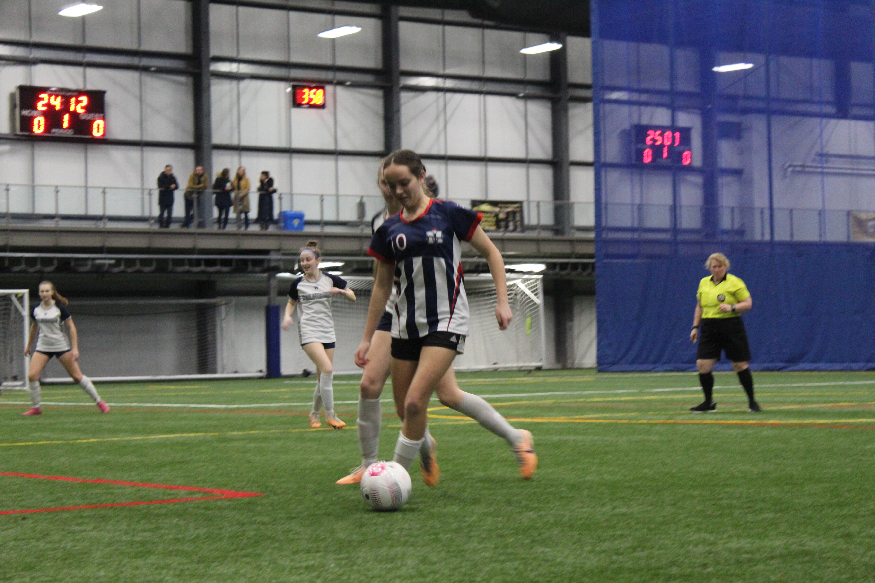 a group of women playing indoor soccer