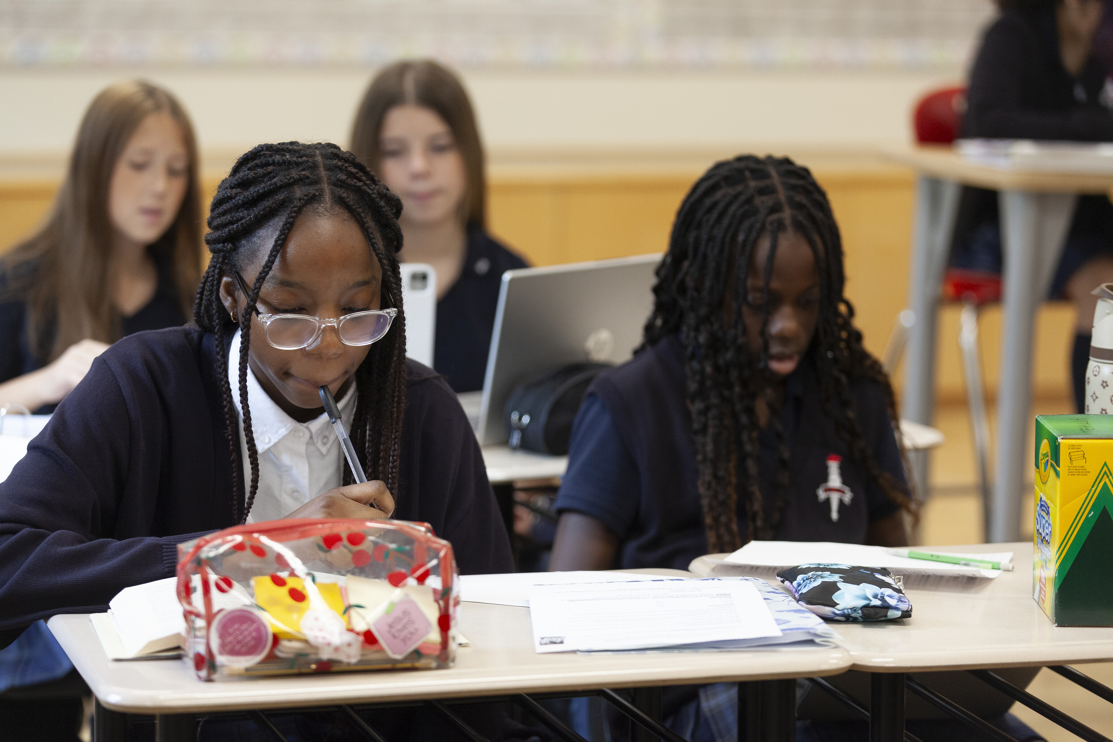 A group grade 7 students sitting and studying inside a classroom