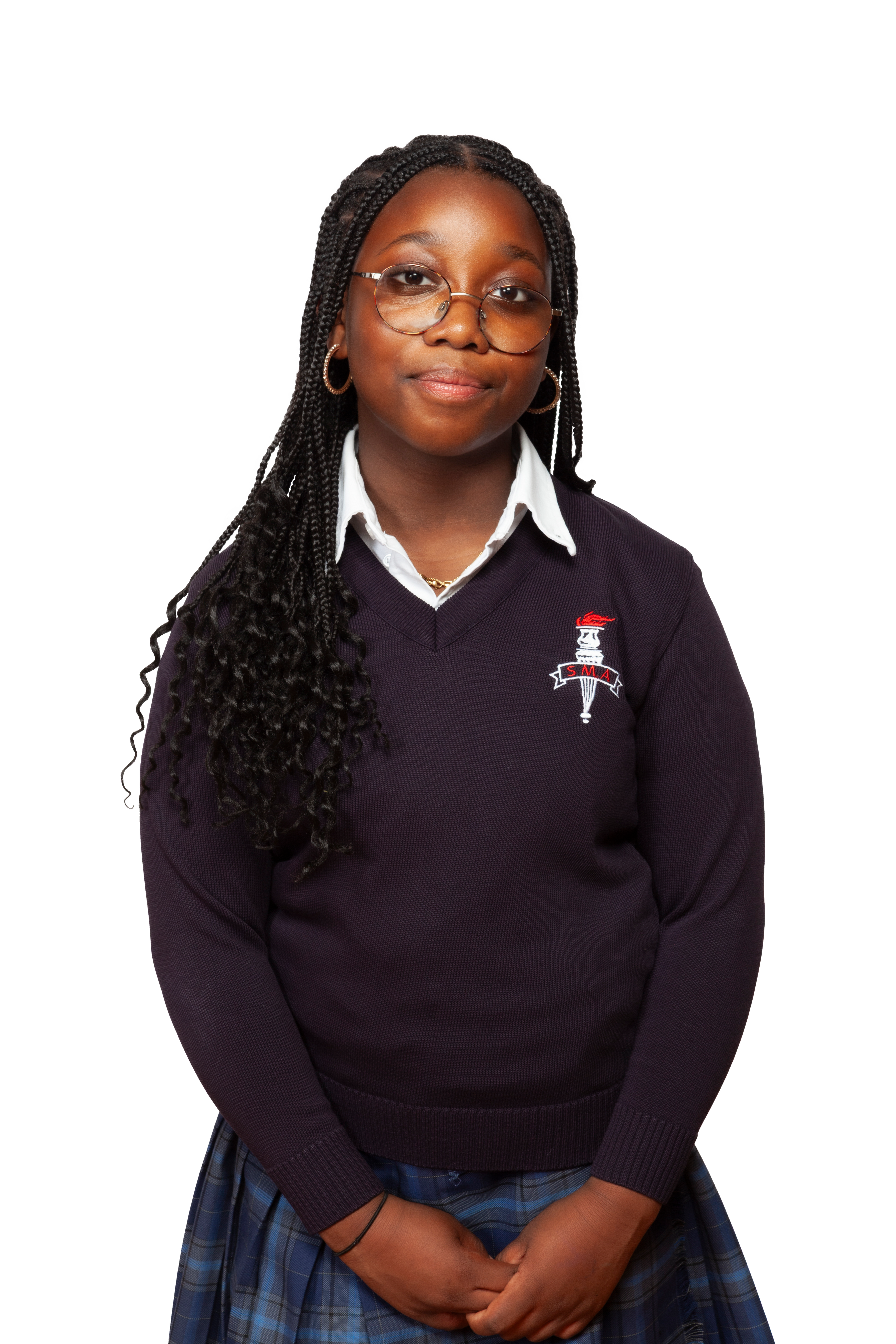 A uniformed student wears a plaid skirt, white button-down shirt and dark v-neck.