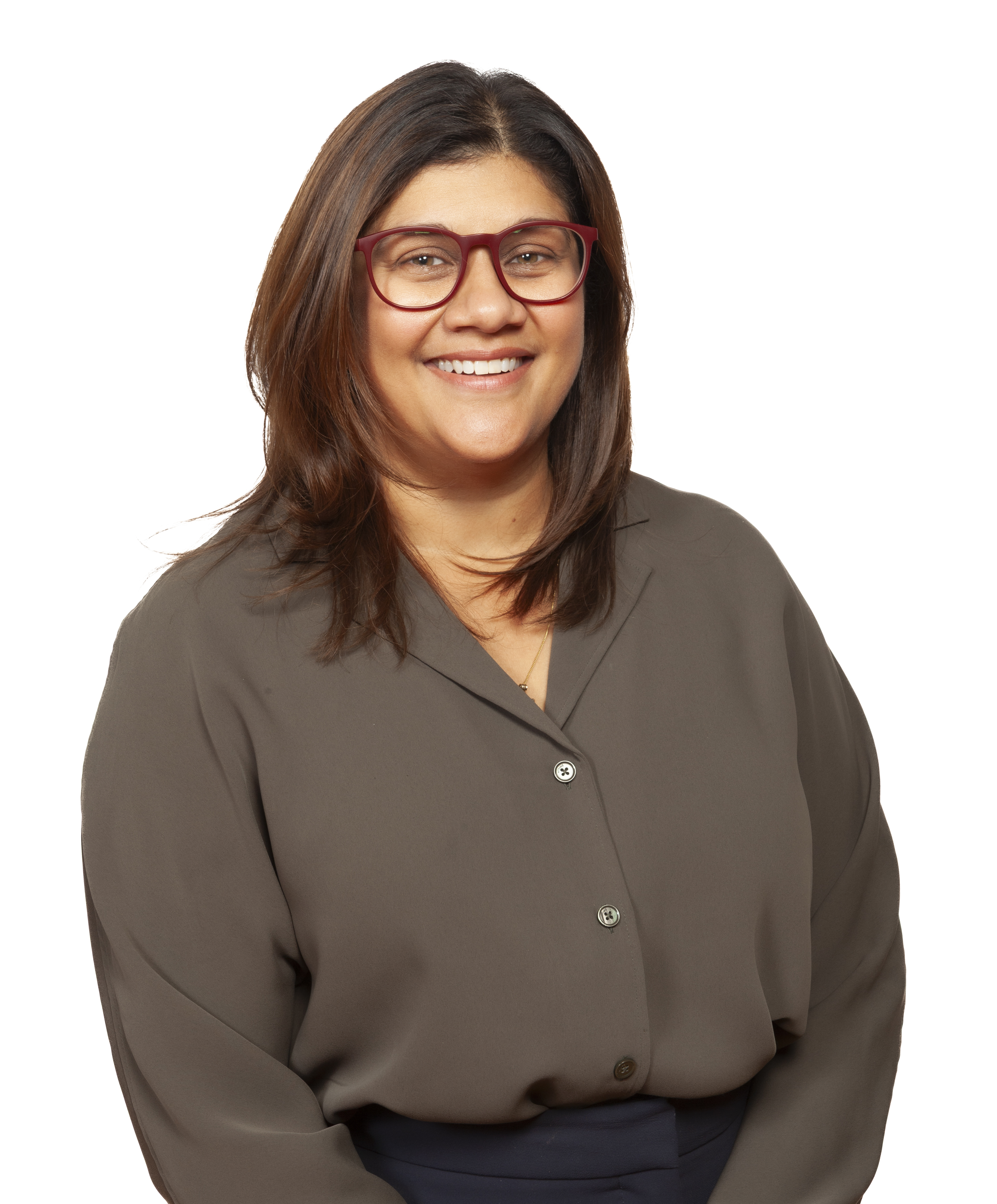 A smiling Sandra Martin, Alumnae Engagement Coordinator at St. Mary's Academy, in a dark beige, long sleeves shirt