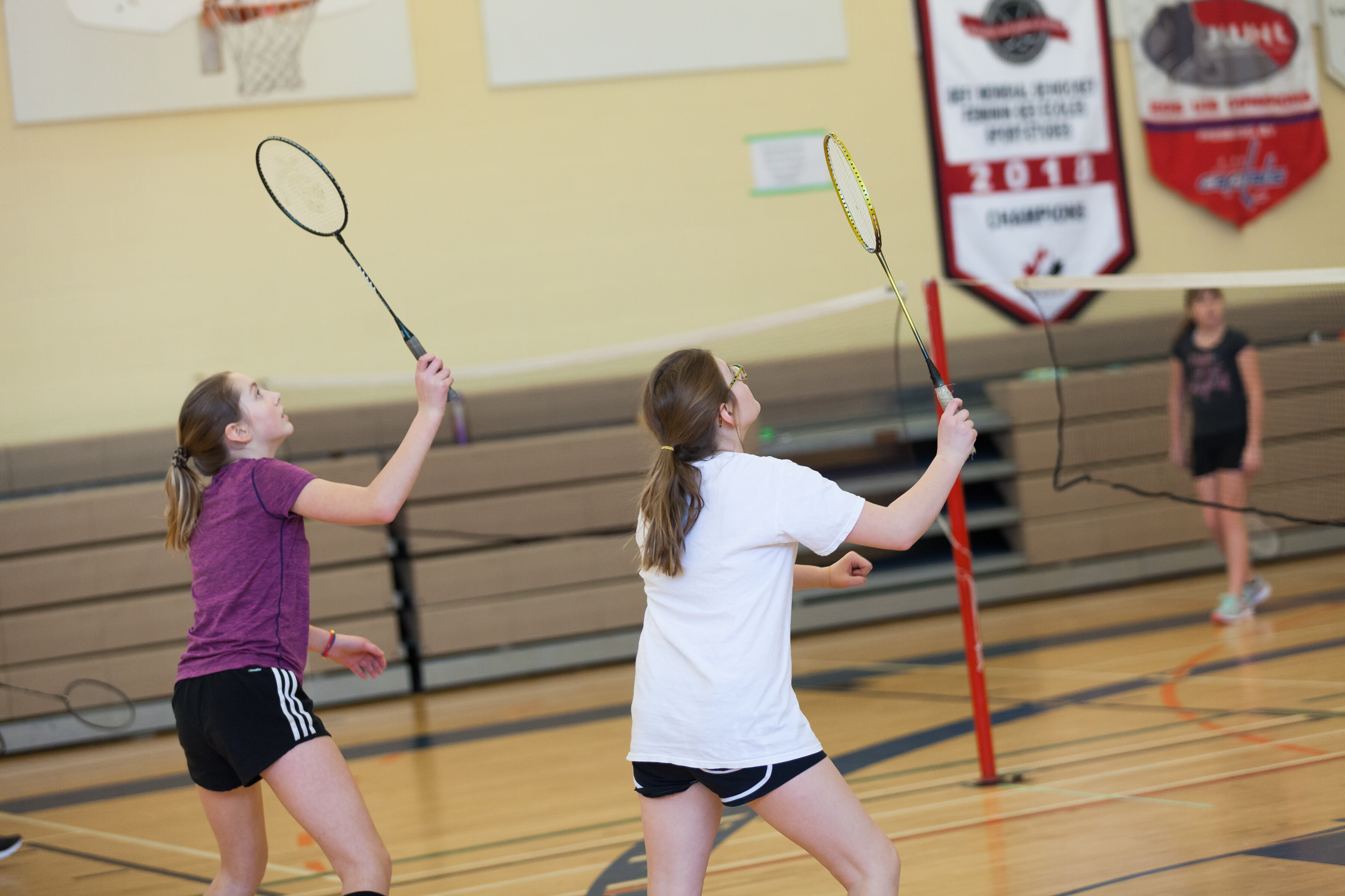 two girls playing badminton